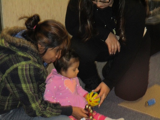 A child is playing with bells and sound makers